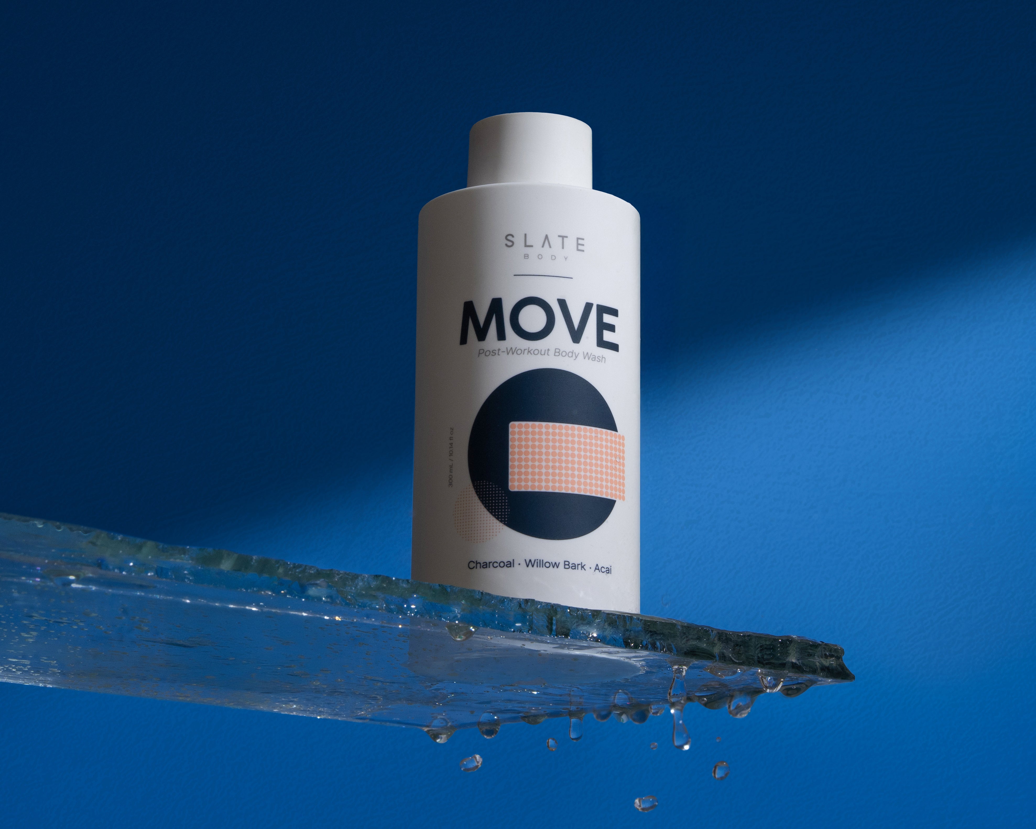 Bottle of Slate body Move body wash product on a blue background