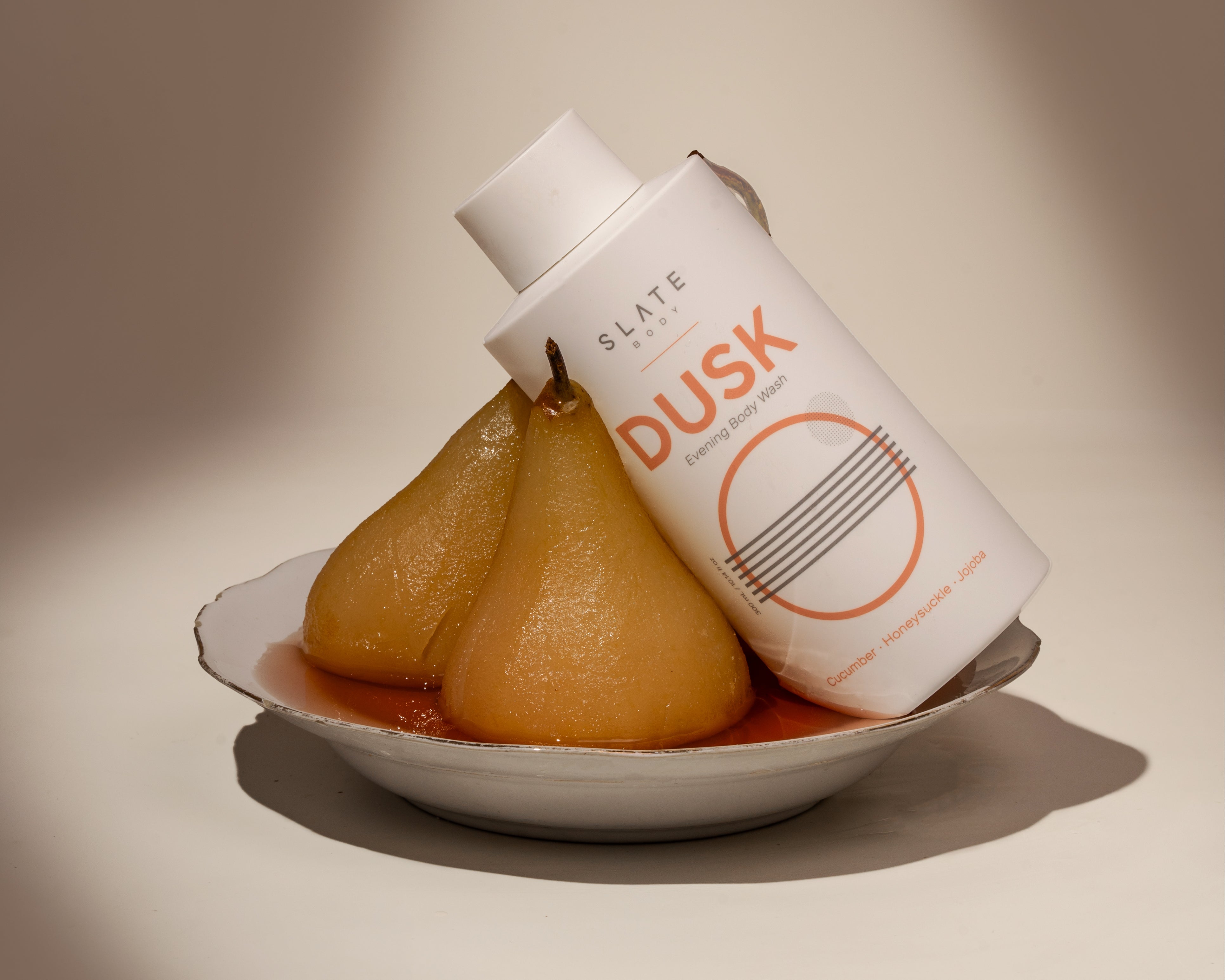 SLATE Body DUSK- evening body wash smells like Lotus and Jasmine. Set against a backdrop of poached pears