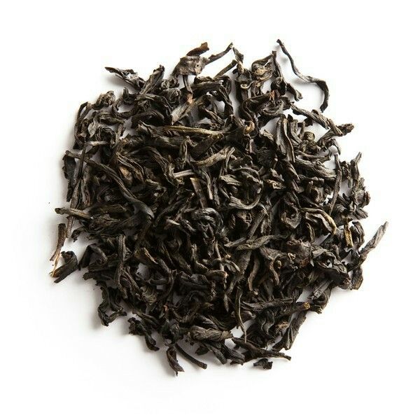 Dry black tea leaves on a white background