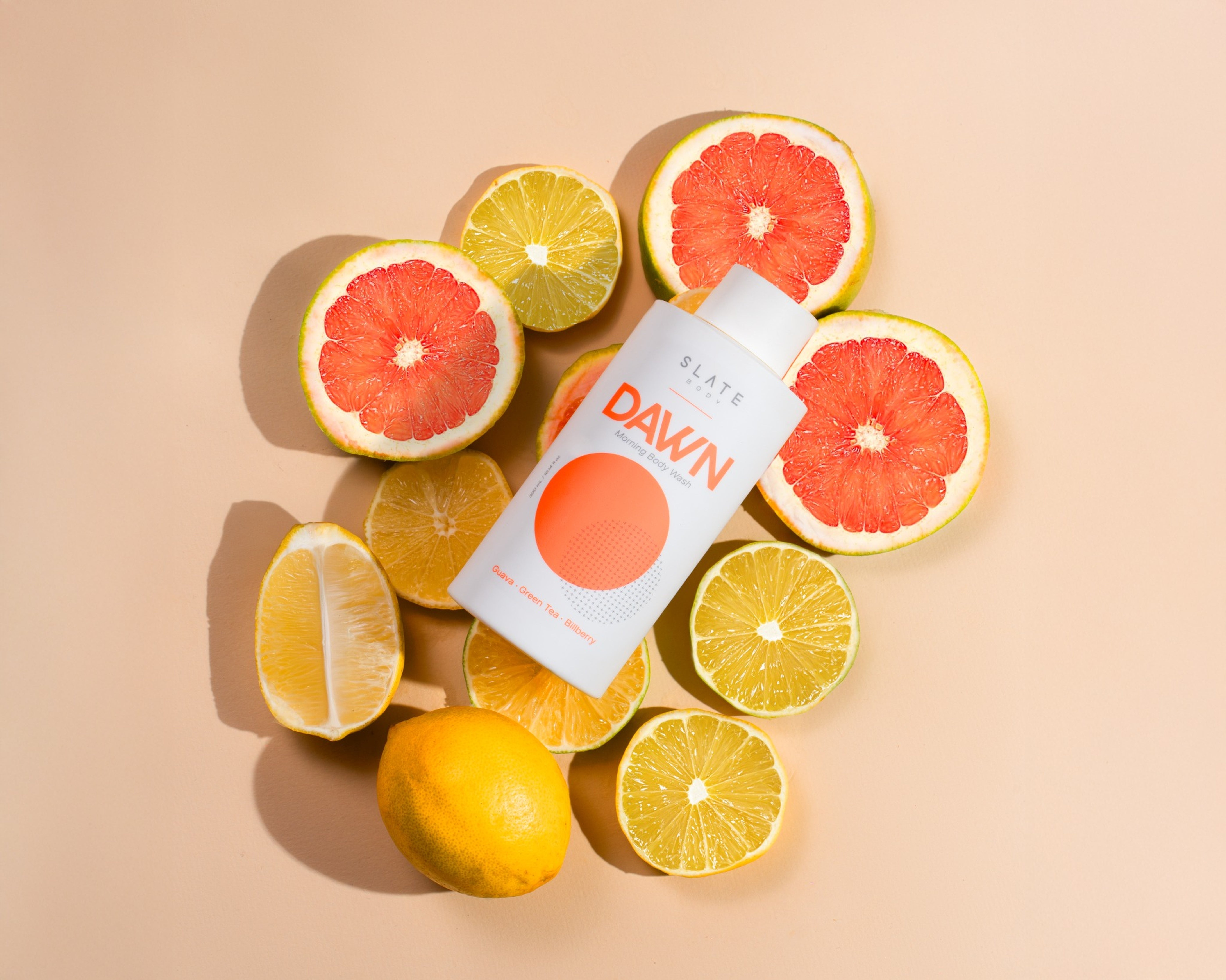 SLATE Body DAWN – morning body wash with guava, green tea, and bilberry, shown in golden sunrise light for an uplifting, fresh start
