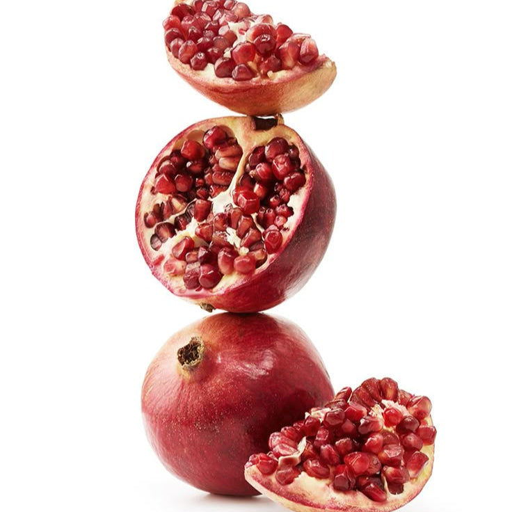 Stack of pomegranates on a white background - SLATE Body PLAY Body Wash
