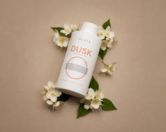 Bodycare product labeled 'DUSK' by Slate body with flowers on a beige background